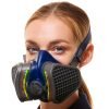 Close-up of a woman wearing a blue GVS respiratory mask with black filters