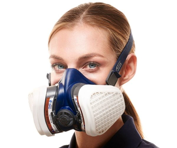 Woman wearing a blue GVS half-mask respirator with white A2P3 R D filters.