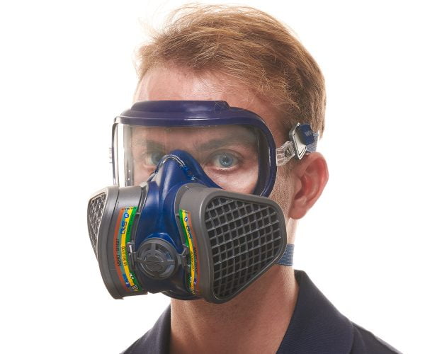 Man wearing a blue GVS half-mask respirator with black ABEK1 filters and protective goggles.