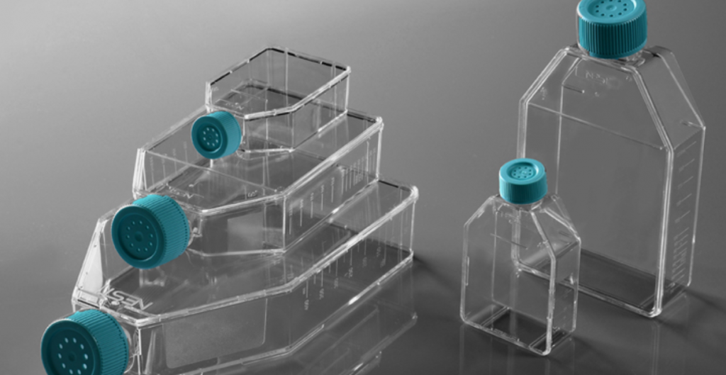 Clear plastic containers with blue caps, used in laboratory settings for testing bacterial filters.