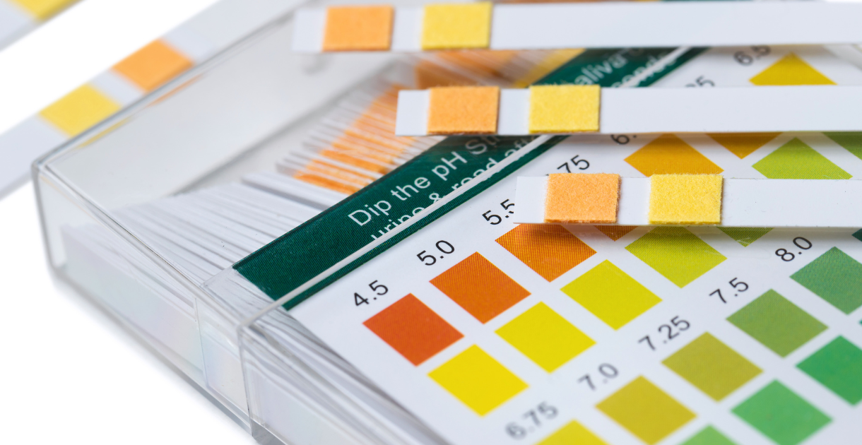 Close-up of pH test strips used in laboratory settings for evaluating syringe filters.