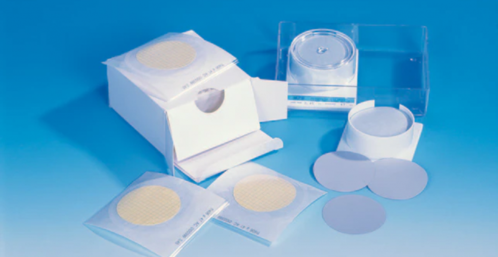 Packaged circular filters, potentially for use in bacterial filter applications.