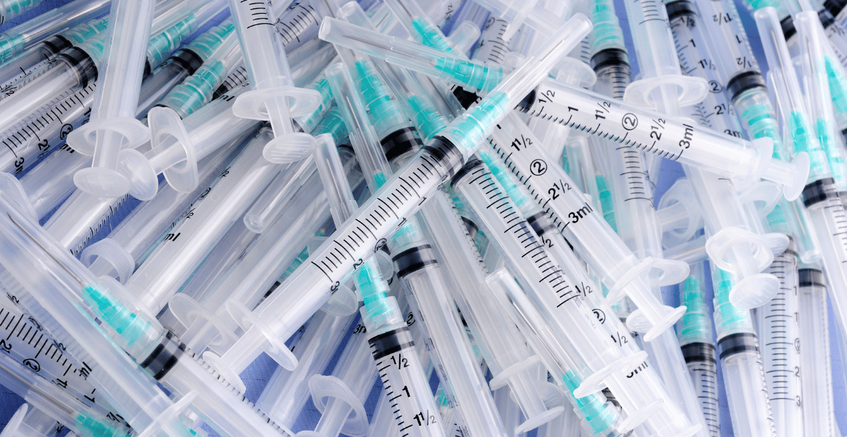 Pile of syringes emphasizing the need for syringe filters in medical settings.